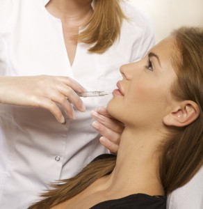 woman receiving Denver dermal filler injection in the lip